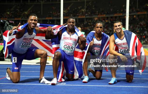 Chijindu Ujah, Zharnel Hughes, Adam Gemili and Harry Aiknes-Aryeetey of Great Britain celebrate after winning gold in the Men's 4x100 metres relay...