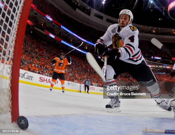 Simon Gagne of the Philadelphia Flyers scores a goal against Antti Niemi and Niklas Hjalmarsson of the Chicago Blackhawks in the second period in...