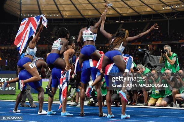 The British men's and women's 4x100m relay teams pose for photographers after the men's 4x100m relay final during the European Athletics...