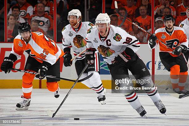 Jonathan Toews of the Chicago Blackhawks handles the puck against Ville Leino of the Philadelphia Flyers in Game Three of the 2010 NHL Stanley Cup...