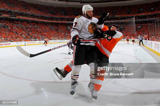 Brent Seabrook of the Chicago Blackhawks checks Arron Asham of the Philadelphia Flyers in Game Three of the 2010 NHL Stanley Cup Final at Wachovia...