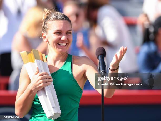 Simona Halep of Romania holds the trophy during the post game ceremony after defeating Sloane Stephens 7-6, 3-6, 6-4 in the final on day seven of the...