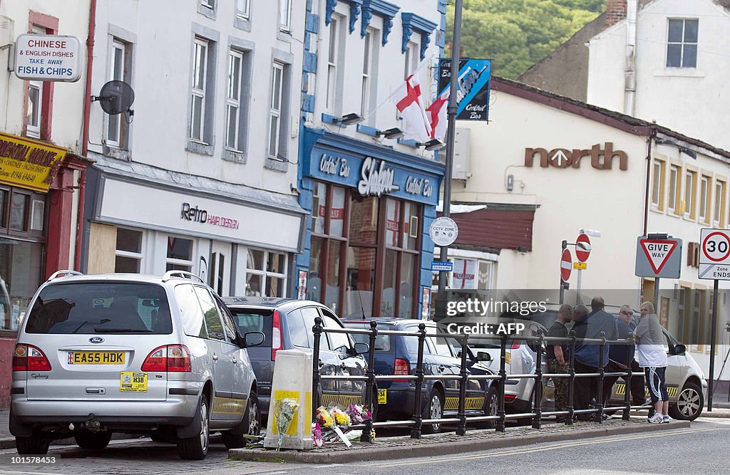 Taxi drivers chat at a taxi rank on Duke