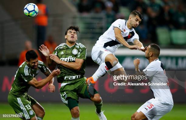 Luan Garcia and Bruno Henrique of Palmeiras fight for the ball with Thiago Galhardo and Leandro Castan of Vasco da Gama during the match between...