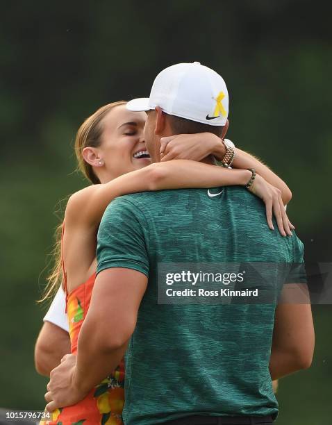 Brooks Koepka of the United States celebrates with his girlfriend, Jena Sims, after winning the 2018 PGA Championship with a score of -16 at...