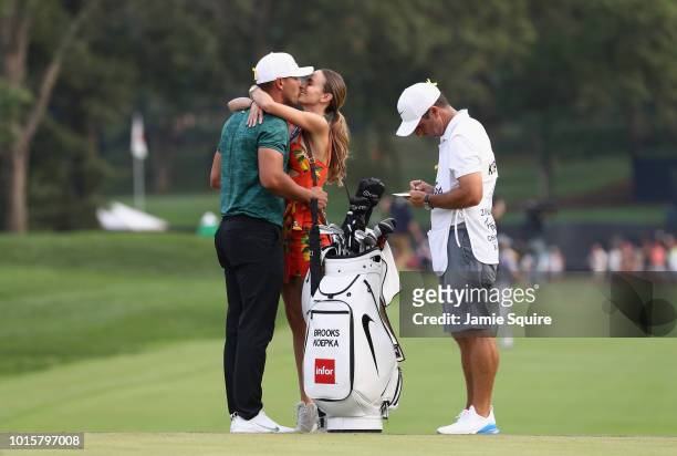 Brooks Koepka of the United States kisses his girlfriend, Jena Sims, after winning the 2018 PGA Championship with a score of -16 at Bellerive Country...