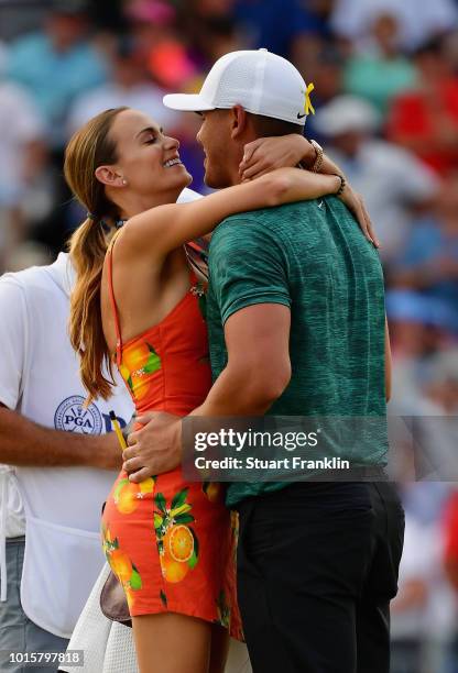 Brooks Koepka of the United States kisses his girlfriend, Jena Sims, after winning the 2018 PGA Championship with a score of -16 at Bellerive Country...