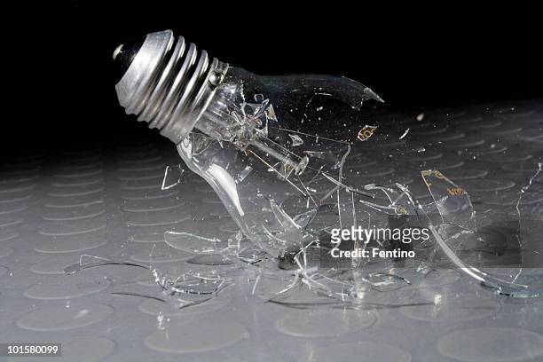 shattering light bulb - broken lamp stockfoto's en -beelden
