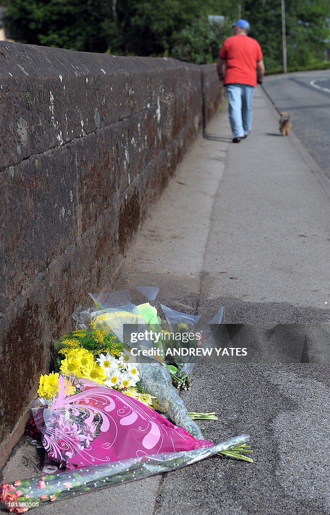 Floral tributes are left on a bridge on