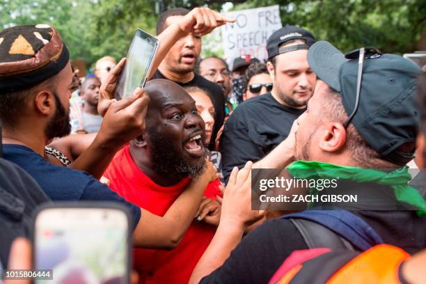 Antifa and counter protestors to a far-right rally argue during the Unite the Right 2 Rally in Washington, DC, on August 12, 2018. - Last year's...