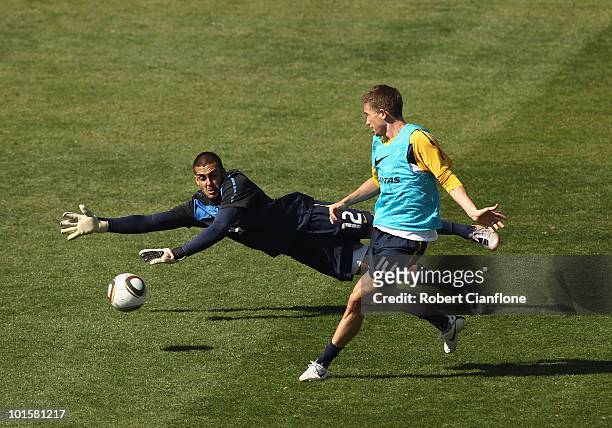Harry Kewell of Australia gets the ball past goalkeeper Adam Federici during an Australian Socceroos training session at St Stithians College on June...
