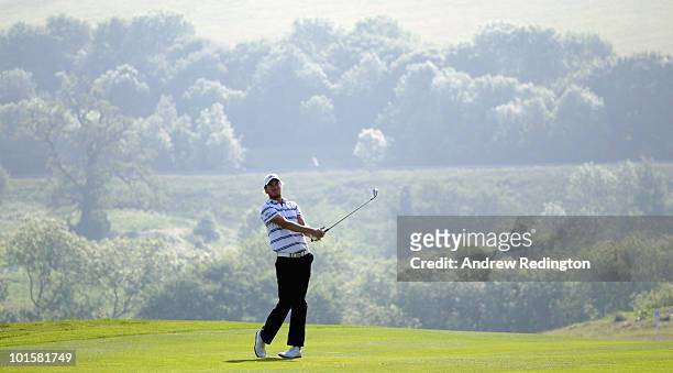 Chris Wood of England hits his second shot on the 16th hole during the first round of the Celtic Manor Wales Open on The Twenty Ten Course at The...
