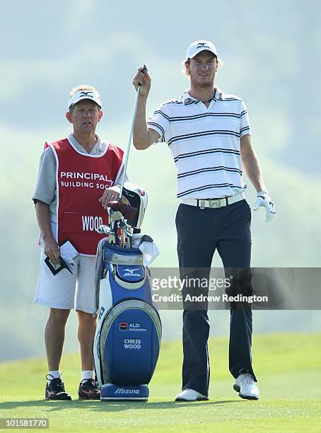 Chris Wood of England waits with his caddie Dave McNeilly on the 16th hole during the first round of the Celtic Manor Wales Open on The Twenty Ten...