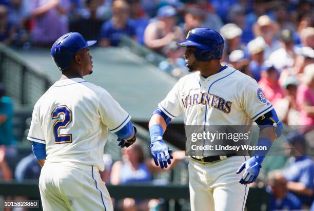 Jean Segura of the Seattle Mariners greets Nelson Cruz after he hit a home run against the Toronto Blue Jays in the seventh inning at Safeco Field on...