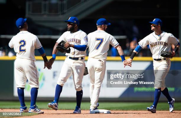 Jean Segura of the Seattle Mariners greets Denard Span and Andrew Romine greets Mitch Haniger, right after their win over the Toronto Blue Jays at...