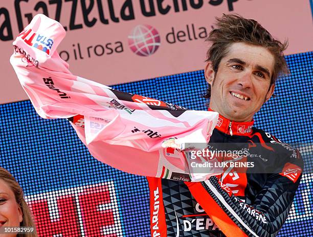 Spanish rider David Arroyo Duran , celebrates winning the pink jersey on the podium of stage 18 of the 93rd Giro of Italia, from Levico Terme to...