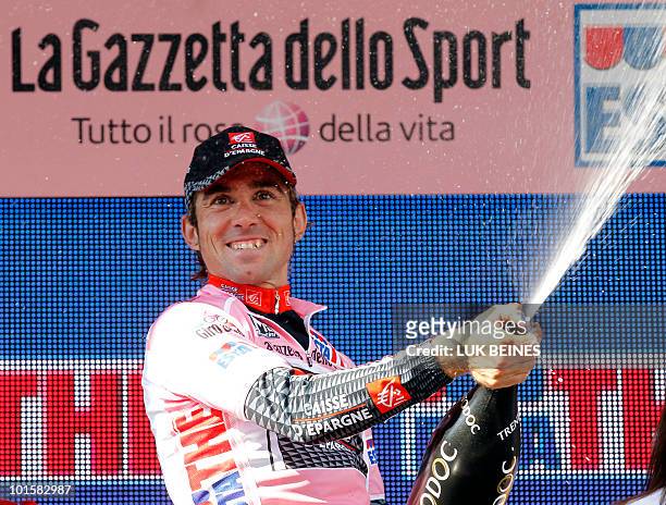 Spanish rider David Arroyo Duran , celebrates winning the pink jersey on the podium of stage 18 of the 93rd Giro of Italia, from Levico Terme to...