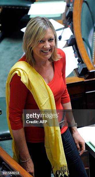 Chamber member Corinne de Parmentier dressed in the colours of the Belgian flag smiles during the plenary session at the federal parliament, in...
