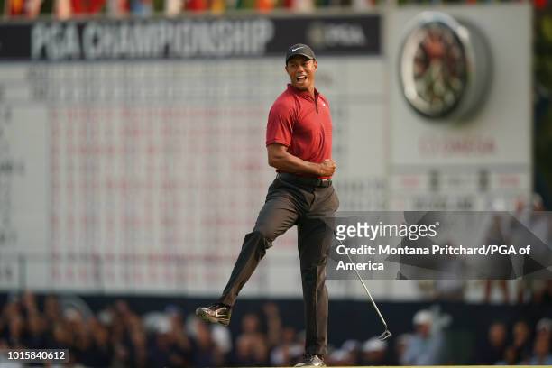 August 12: Tiger Woods of the US reacts to making his putt for birdie on the 18th hole during the final round of the 100th PGA Championship held at...