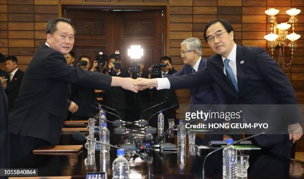 South Korean Unification Minister Cho Myoung-gyun shakes hands with his North Korean counterpart Ri Son Gwon during their meeting at the northern...