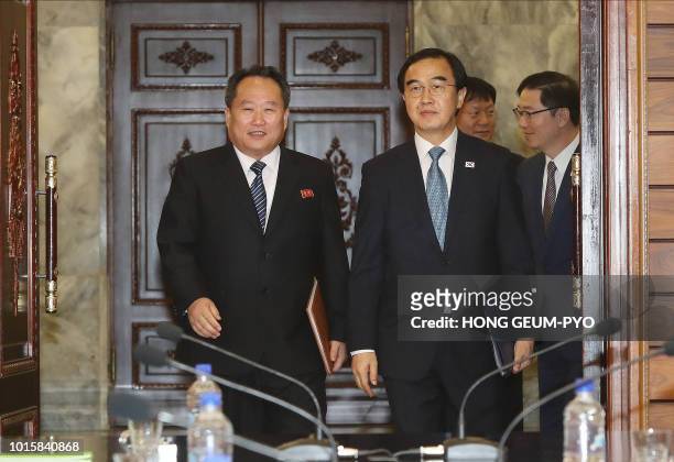 South Korean Unification Minister Cho Myoung-gyun and his North Korean counterpart Ri Son Gwon walk into a meeting room for their talks at the...