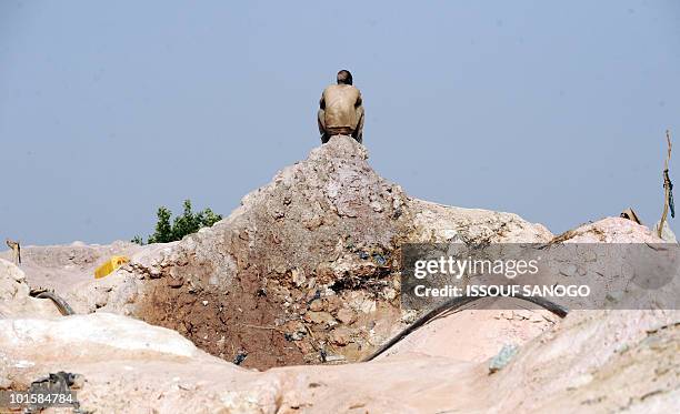 Gold miner takes a break after coming out of a hole where he was digging and looking for gold in Namisgma, the largest gold washing site in the...