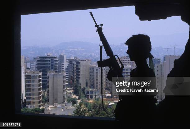 An Amal militia man armed with an M16 automatic assault rifle stands at a sniper position outside Bourj el-Barajneh Palestinian refugee camp in the...