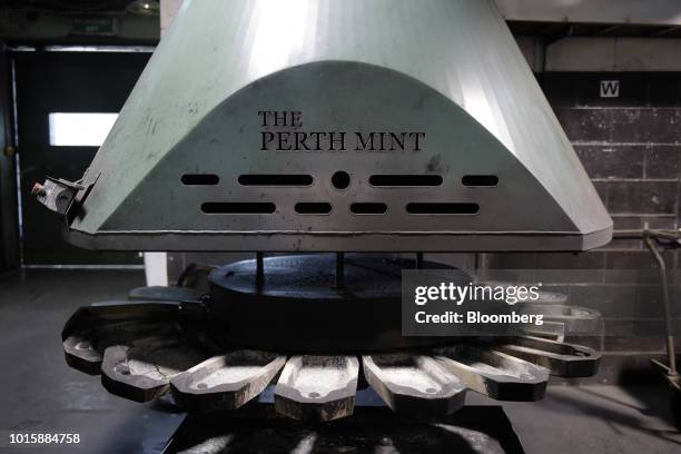 An extraction hood hangs above silver anode molds in the furnace room at the Perth Mint Refinery, operated by Gold Corp., in Perth, Australia, on...