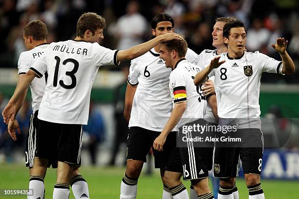 Philipp Lahm of Germany celebrates after scoring his team's first goal with team mates Lukas Podolski, Thomas Mueller, Sami Khedira, Bastian...