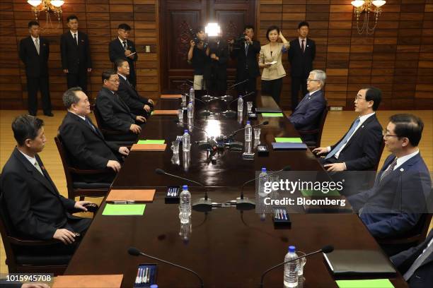 Cho Myoung-gyon, South Korea's unification minister, seated second right, and Ri Son Gwon, chairman of North Korea's Committee for the Peaceful...