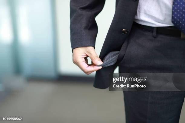 bankrupt, close-up of man's empty pocket - werkloos stockfoto's en -beelden