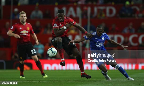 Paul Pogba of Manchester United in action with Ricardo Domingos Barbosa Pereira of Leicester City during the Premier League match between Manchester...