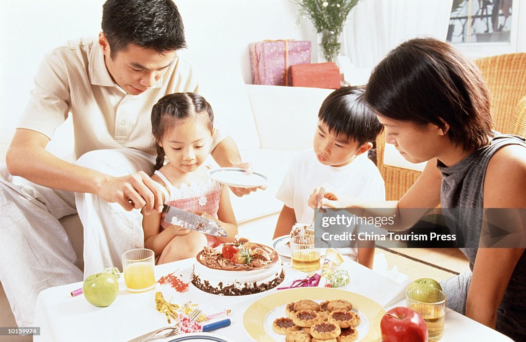 FATHER CUTTING BIRTHDAY CAKE, HONG KONG