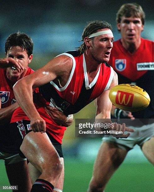 Peter Everitt of St Kilda handpasses forward during the pre season Ansett Cup match between St Kilda and Melbourne at Waverley Park, Melbourne,...