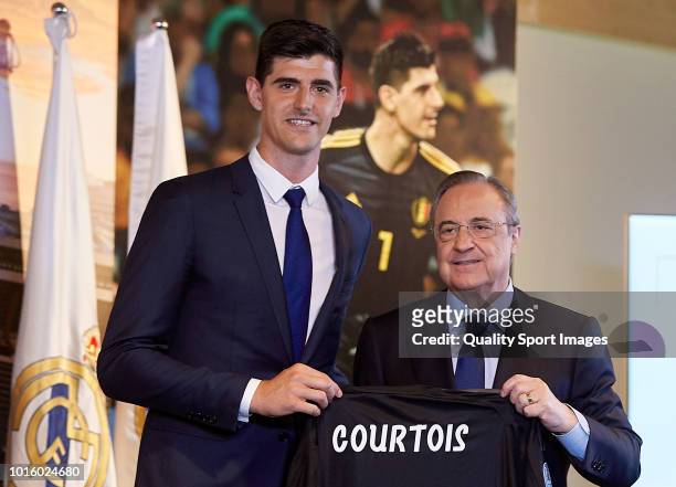 Thibaut Courtois poses with Florentino Perez, President of Real Madrid after being announced as a Real Madrid player during at Estadio Santiago...