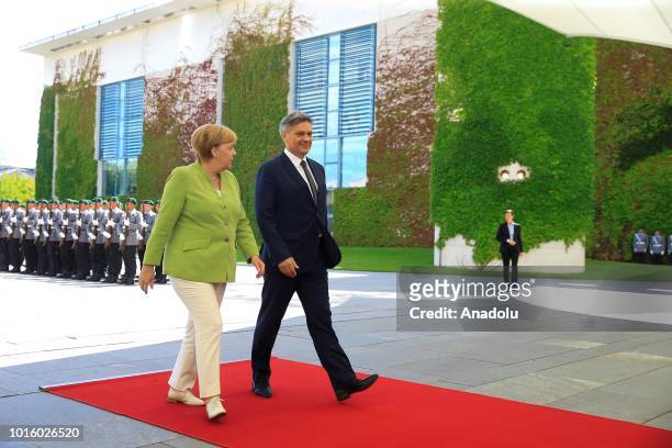 German Chancellor Angela Merkel and Chairman of the Council of Ministers of Bosnia and Herzegovina Denis Zvizdic walk ahead of their meeting...