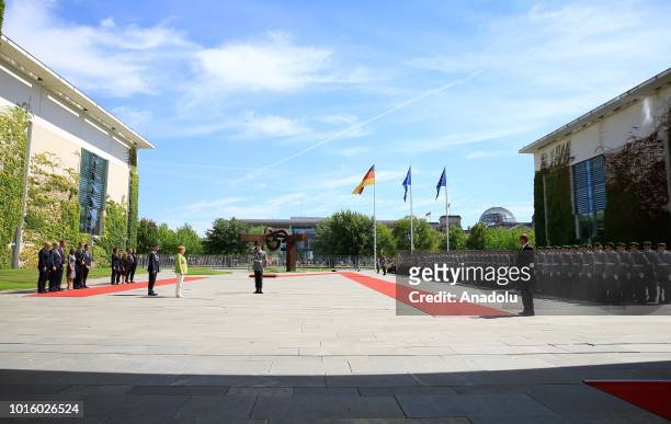 German Chancellor Angela Merkel views the honour guards ahead of a welcoming ceremony for Chairman of the Council of Ministers of Bosnia and...