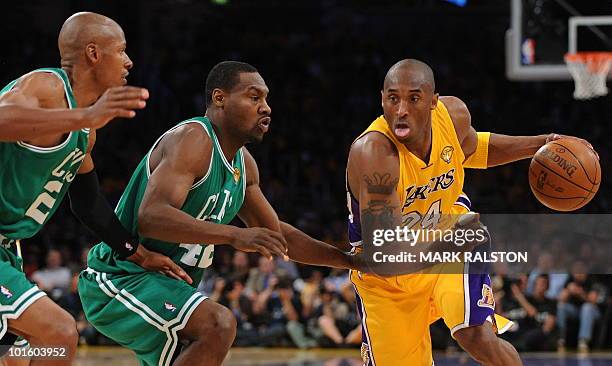 Lakers guard Kobe Bryant tries to get past Boston Celtics players Ray Allen and Tony Allen during game one of the NBA finals against the Boston...