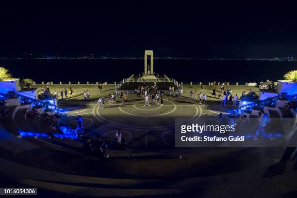 People at the Arena of the Strait of Reggio Calabria during the nightlife in the Via Marina. The Via Marina of Reggio Calabria consists of the four...