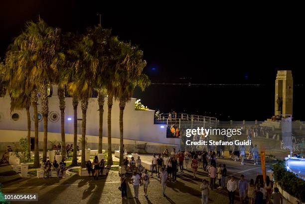 People at the Arena of the Strait of Reggio Calabria during the nightlife in the Via Marina. The Via Marina of Reggio Calabria consists of the four...