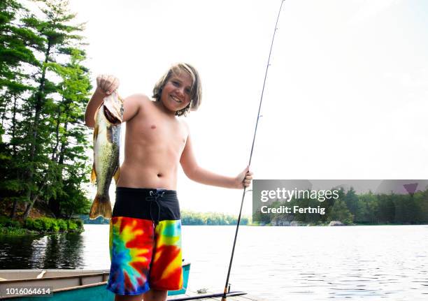 Teenage Boy Holding Largemouth Bass At Lake High-Res Stock Photo - Getty  Images