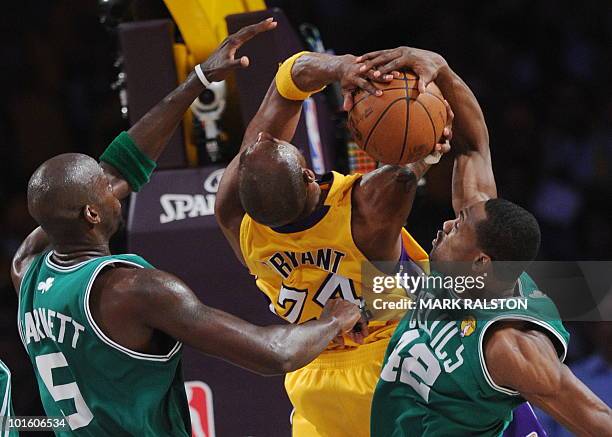 Lakers guard Kobe Bryant is blocked by Boston Celtics player Kevin Garnett and Tony Allen is guarded by Boston Celtics player Rajon Rondo before the...