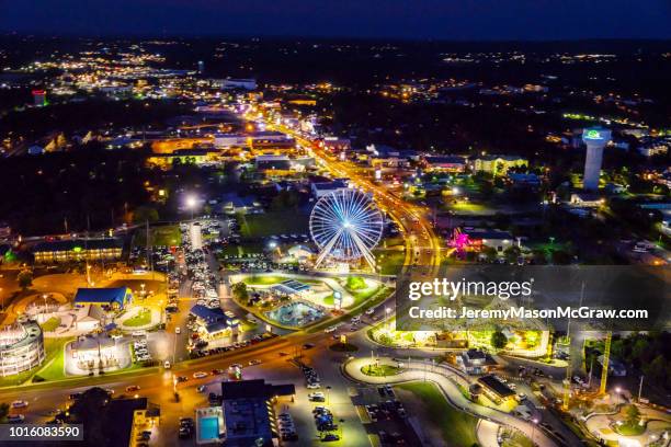 night summer aerial view of hwy 76 strip in branson, missouri - branson missouri stock pictures, royalty-free photos & images