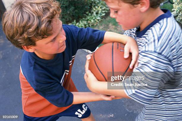 twin boys fighting over basketball - championship day seven stock-fotos und bilder