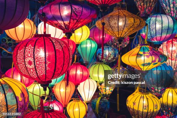 background picture of multi colored chinese lanterns in night - lanterns stock-fotos und bilder