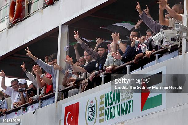 Passengers on the Mavi Marmara greet the passengers of the MV Amal after mechanical problems resulted in MV Amal passengers being relocated to the...