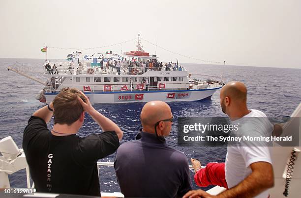 Passengers wave farewell on the "Amal" passenger boat as they set sail from Aghios Nikolaos as part of the Freedom Flotilla bound for Gaza on May 27,...