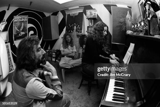 American singer-songwriter Carole King plays the piano to recoord producer Lou Adler and her co-writer Toni Stern in Lou Adler's office in March 1971...