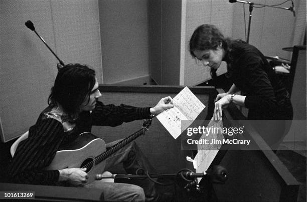 Singer-songwriter Carole King showing James Taylor through chord charts during the recording of her album 'Tapestry' at A&M Records Recording Studio...