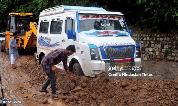 Vehicle is seen stuck on the Bypass road after heavy monsoon showers triggered a landslide, on August 13, 2018 in Jammu, India.